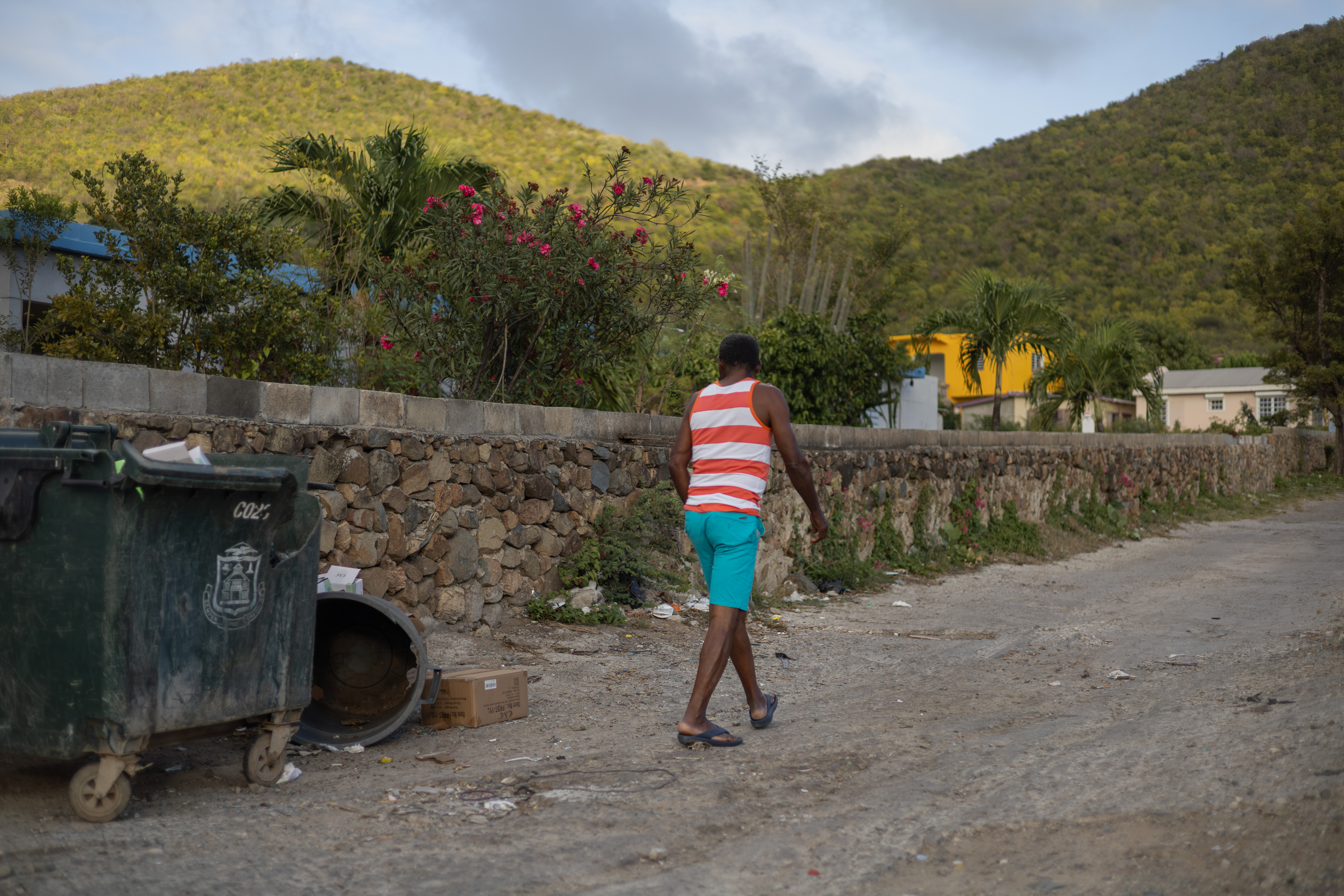 Man walking away across a rocky terrain in Saint-Martin