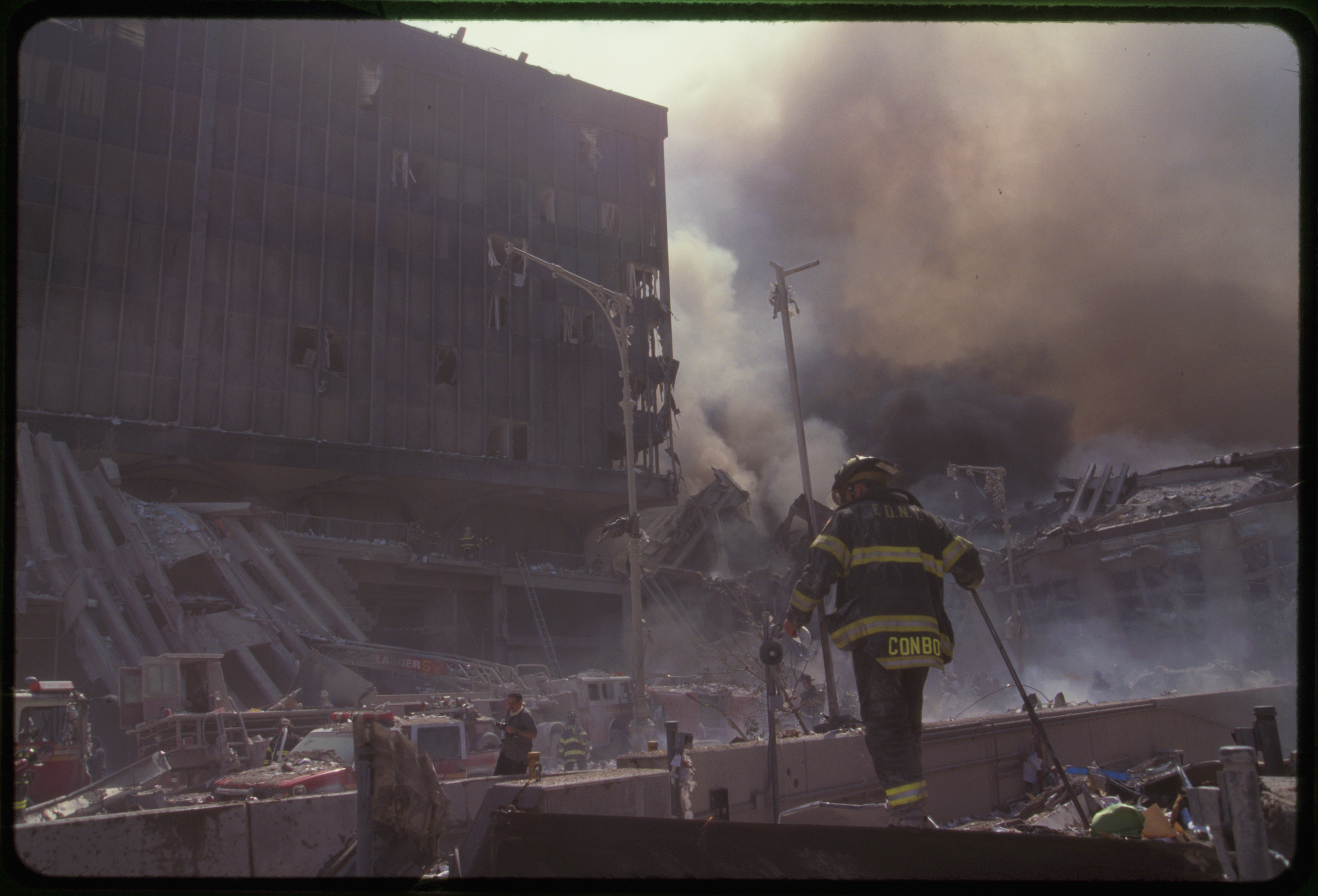 Fire fighters amid smoking rubble following September 11th terrorist attack on World Trade Center, New York City